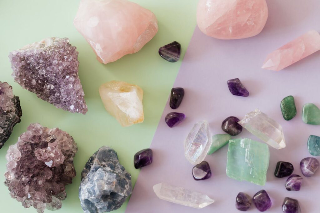 Crystals and Gemstones A variety of crystals and gemstones including amethyst and rose quartz on a pastel background.