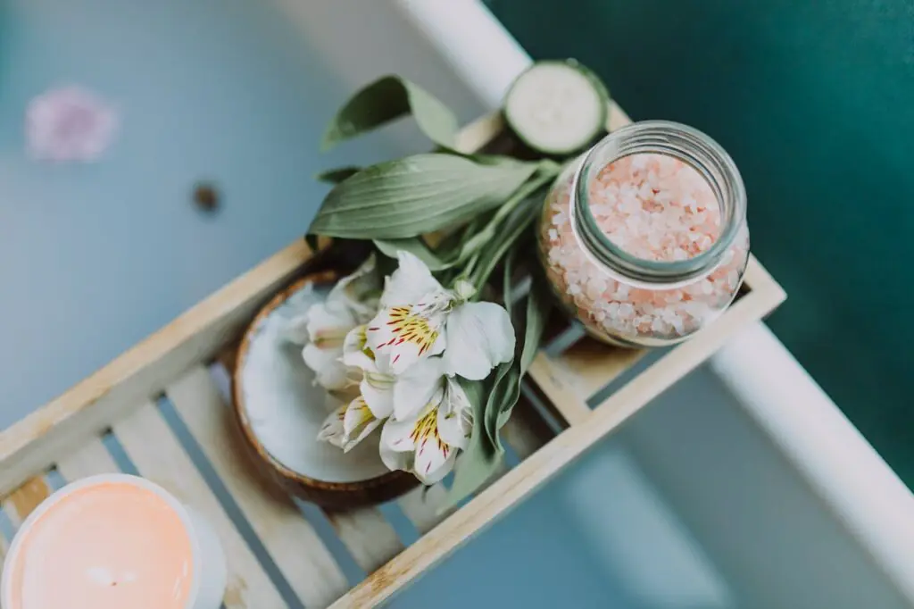 Spa Tray on Bath Spa essentials on a tray with Himalayan salt, flowers, and candles for a relaxing bath.