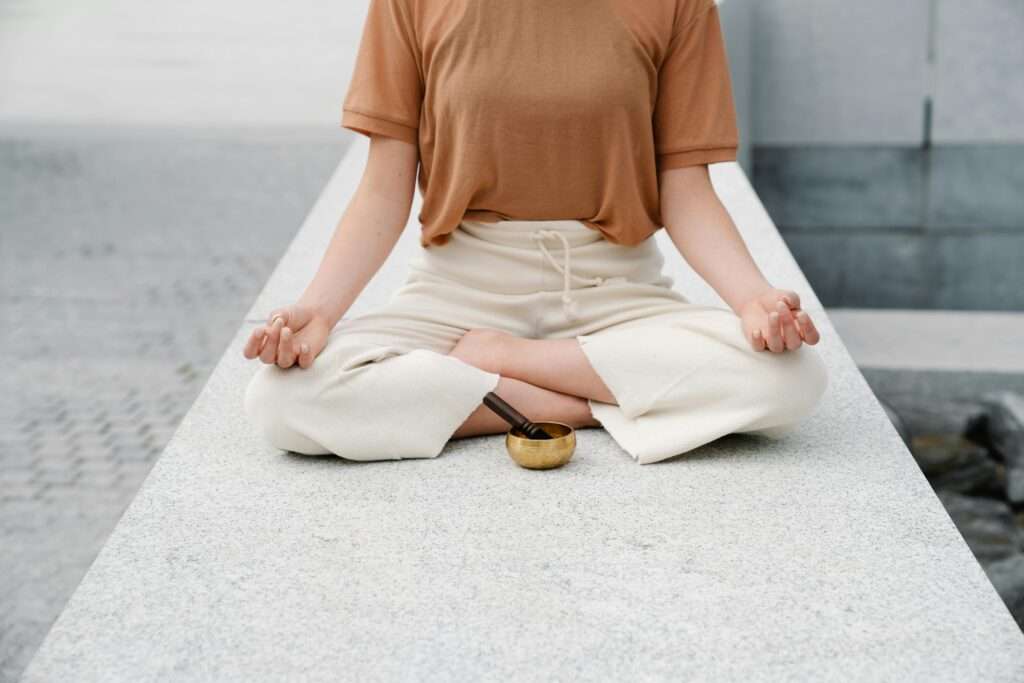 pexels-photo-9031632-9031632 A person meditating outdoors with a singing bowl, embracing serenity and mindfulness.